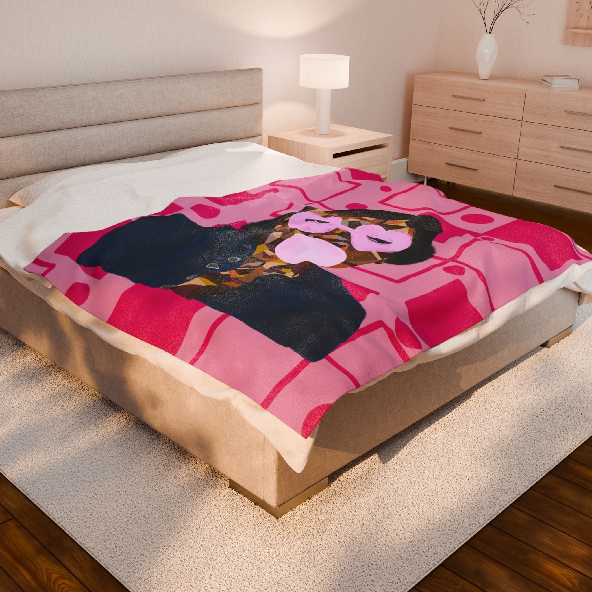 Bed with a colorful blanket featuring a black woman blowing a bubble design in a bedroom setting.
