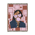 Woven blanket with a geometric pattern and character design on a white background